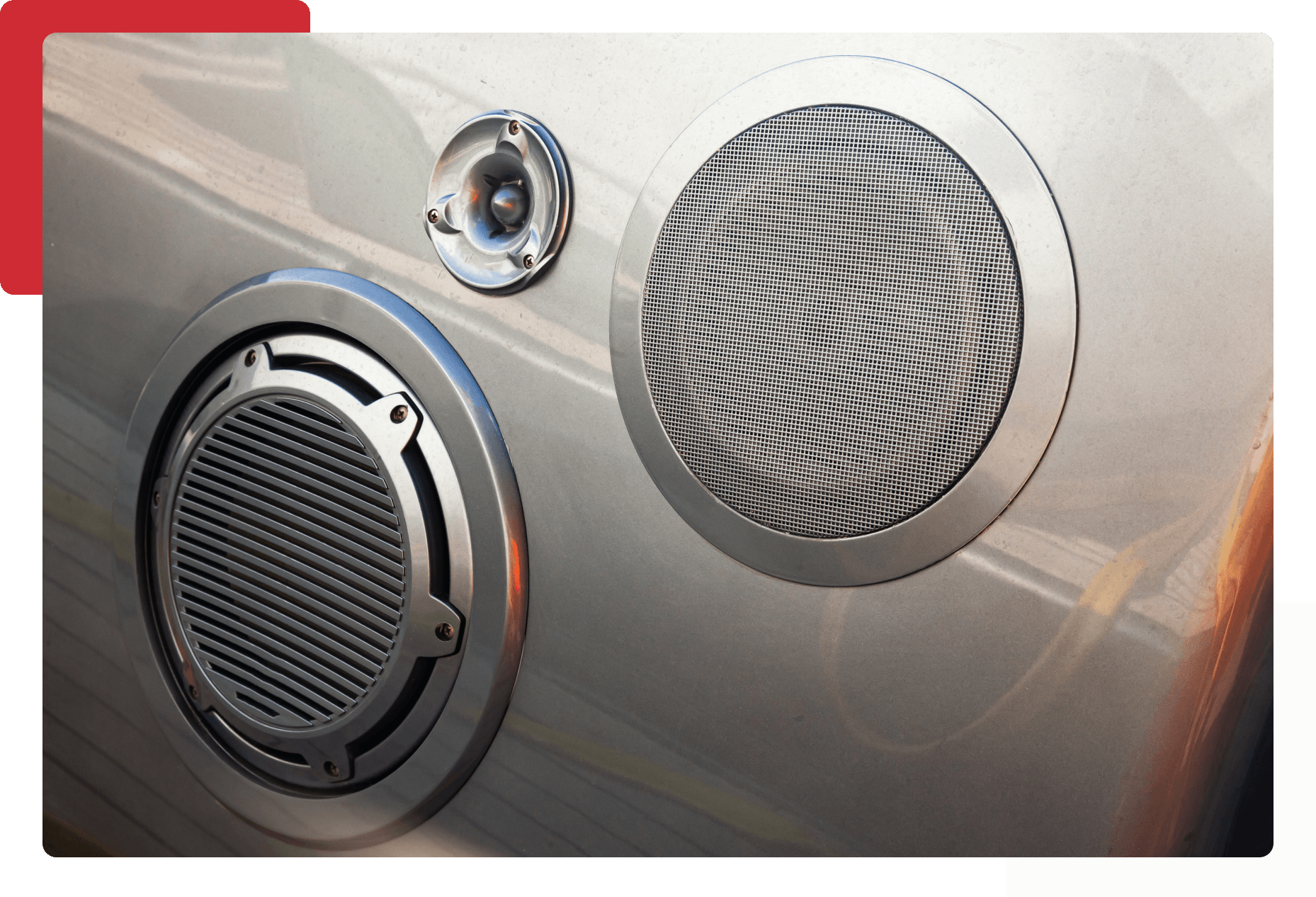 Here's an alt tag for the image: Silver car speakers with grills.