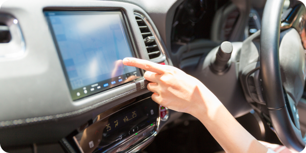 Hand interacting with car's touchscreen.