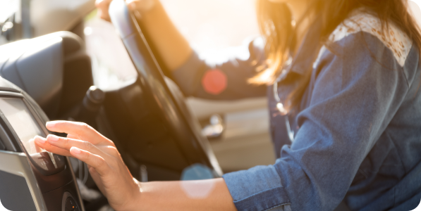 Woman using in-car navigation system.