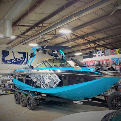 Teal and black Super Air Nautique boat.