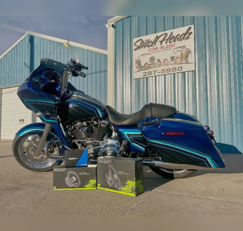 A blue motorcycle parked in front of a building.