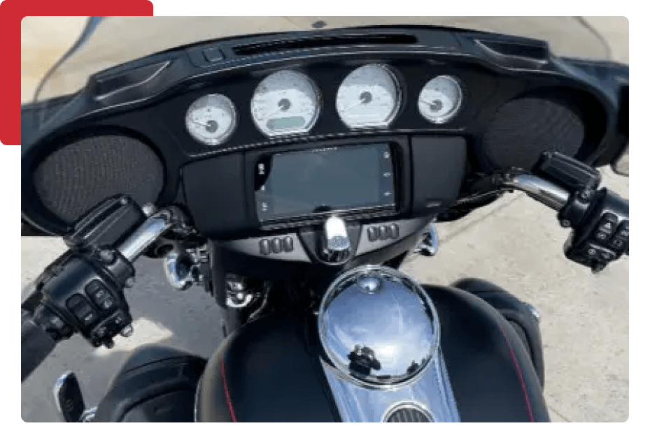 A close up of the dashboard and steering wheel on a motorcycle.