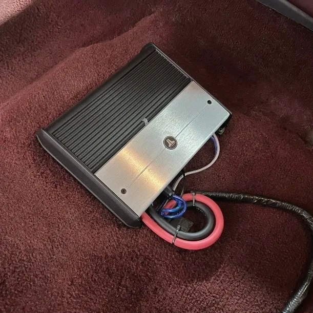 A foot pedal with wires attached to it.